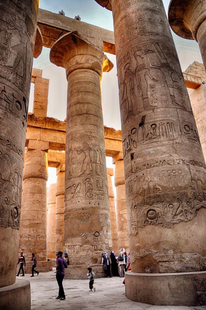 Ancient columns adorned with hieroglyphs in Egypt's Karnak Temple.