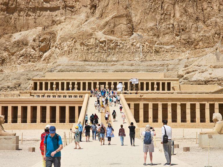 Visitors exploring Hatshepsut Temple in Luxor, Egypt, showcasing ancient architecture.